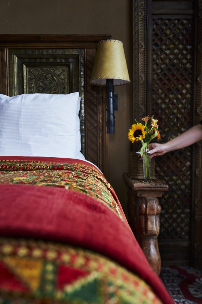 Fresh Sunflowers being placed by the bed at The Inn of The Five Graces
