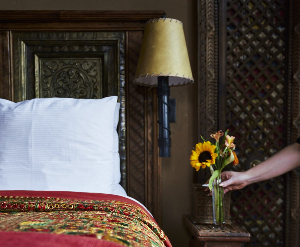 Fresh Sunflowers being placed by the bed at The Inn of The Five Graces